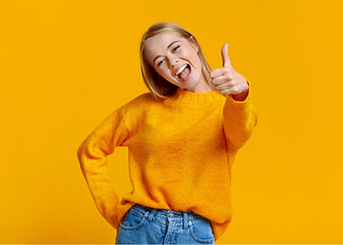 A woman giving an enthusiastic thumbs up
